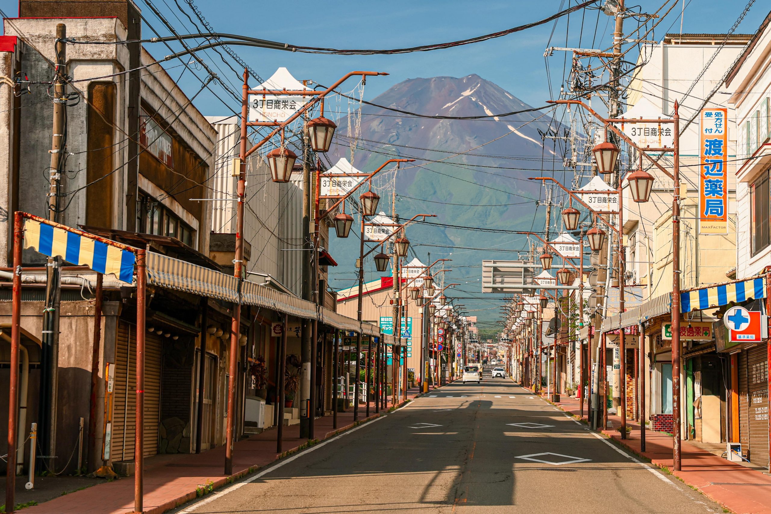 Mount Fuji can be seen from Honchō Street on a Clear Morning with blue skies. Source stock.adobe.com