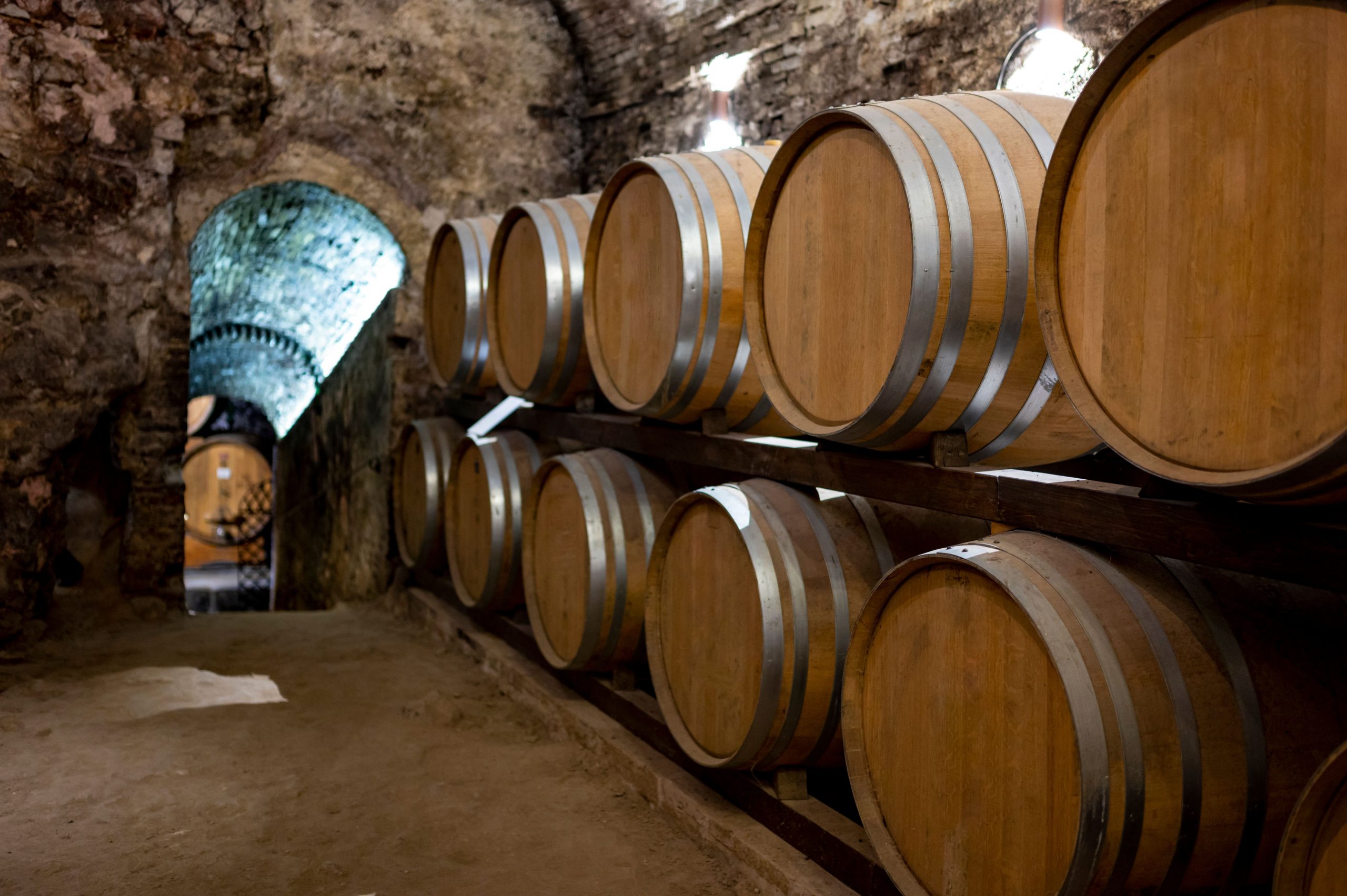 Old red wine barrels used for ageing Vino Nobile di Montepulciano in the historic town of Montepulciano, Tuscany.