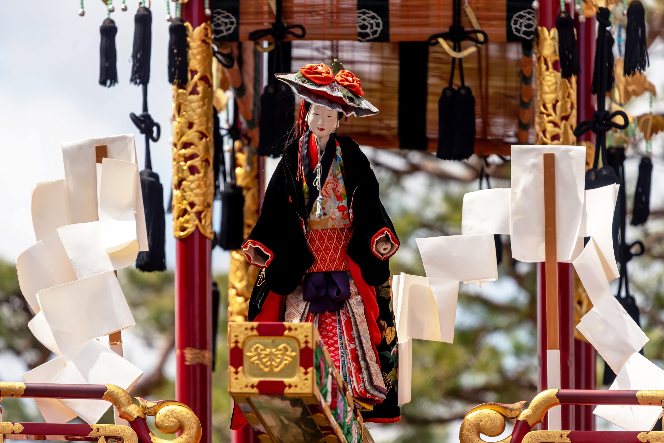 Mechanical marionette on an ornate traditional wooden float during the Takayama Spring Festival.