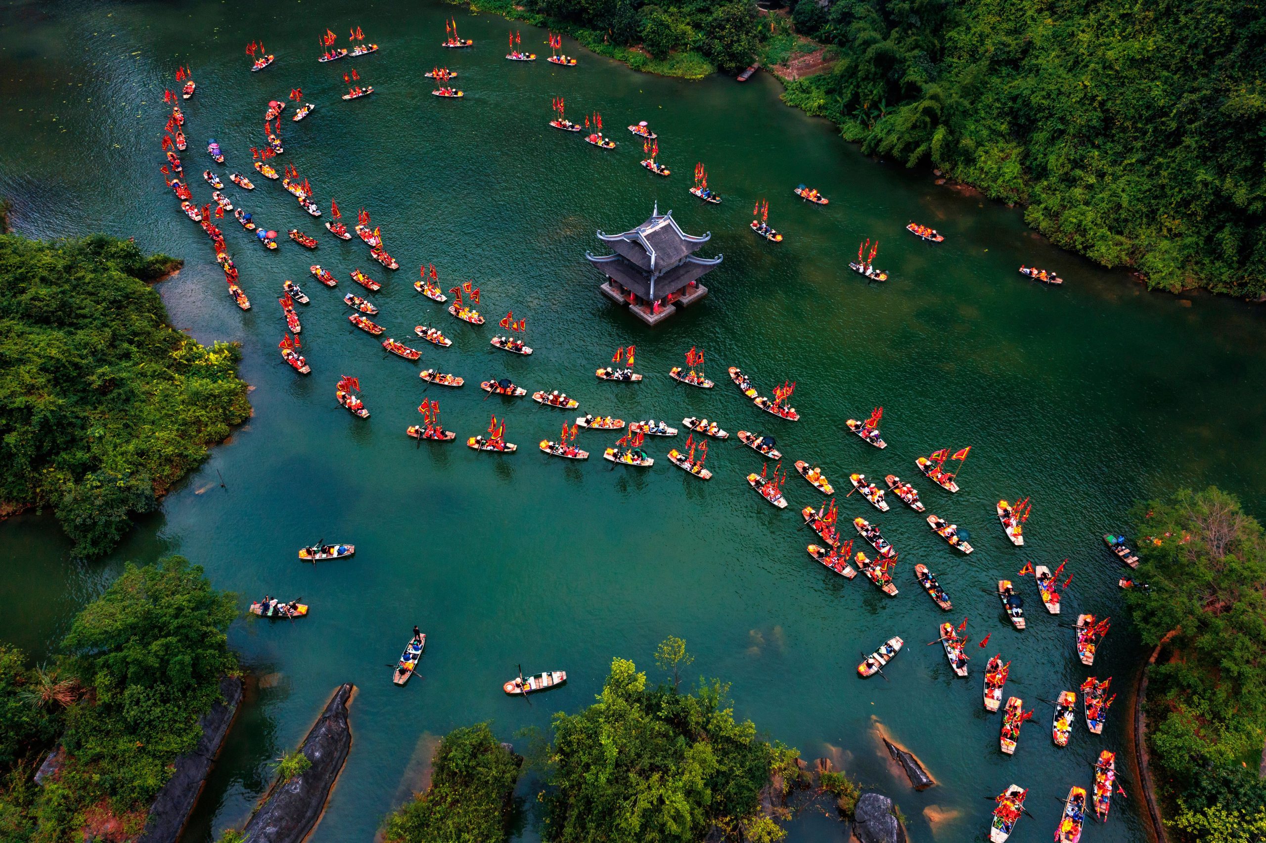 The best way to explore Tam Coc is by boat, rowed by skilled locals.