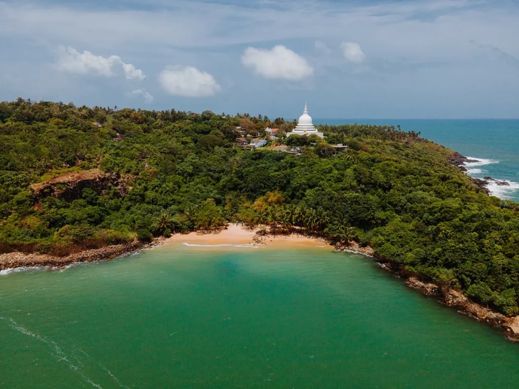 It's generally less crowded than major tourist beaches like Mirissa or Hikkaduwa, offering a peaceful escape.