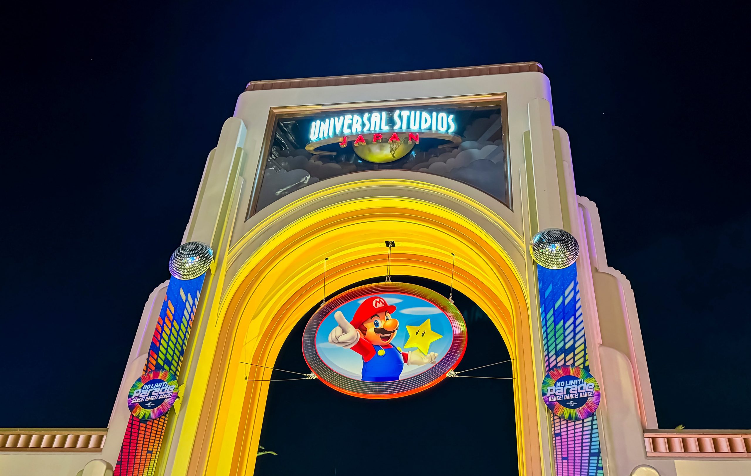 Universal Studios Japan exterior entrance sign at night. Credit oasisamuel - stock.adobe.com