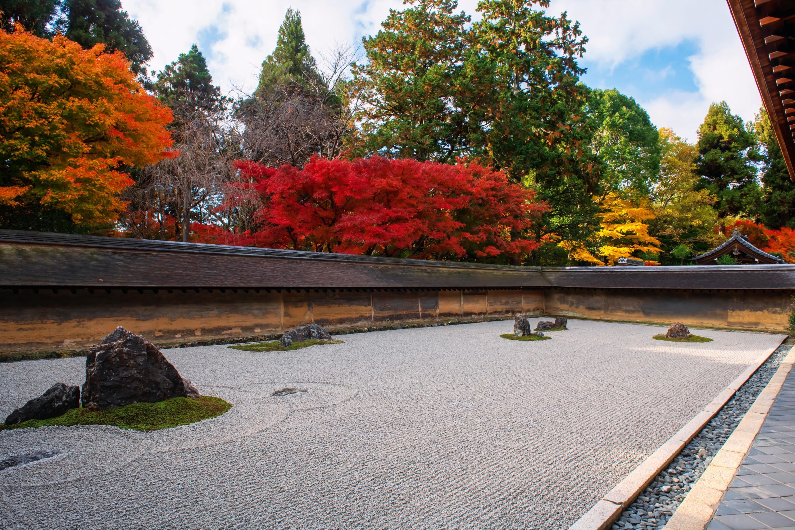 Rock garden in autumn maple leaf colours at Ryoan-ji temple.