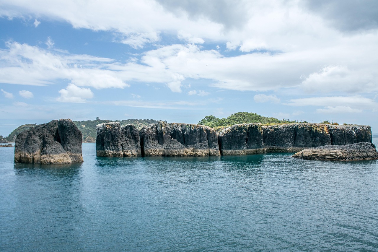Pristine coastline of Great Barrier Island with turquoise waters.