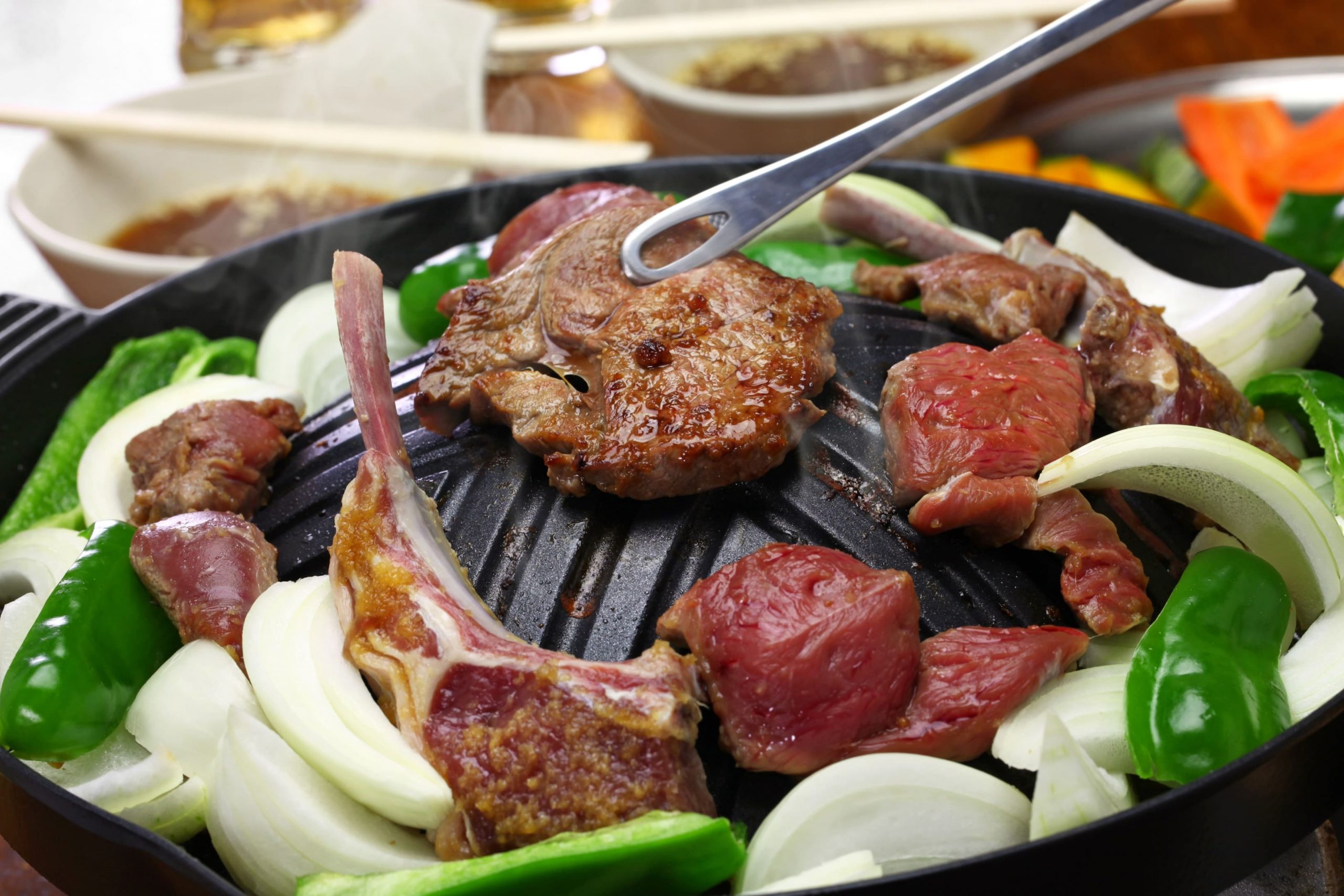 The dish is prepared on a special dome-shaped metal skillet.