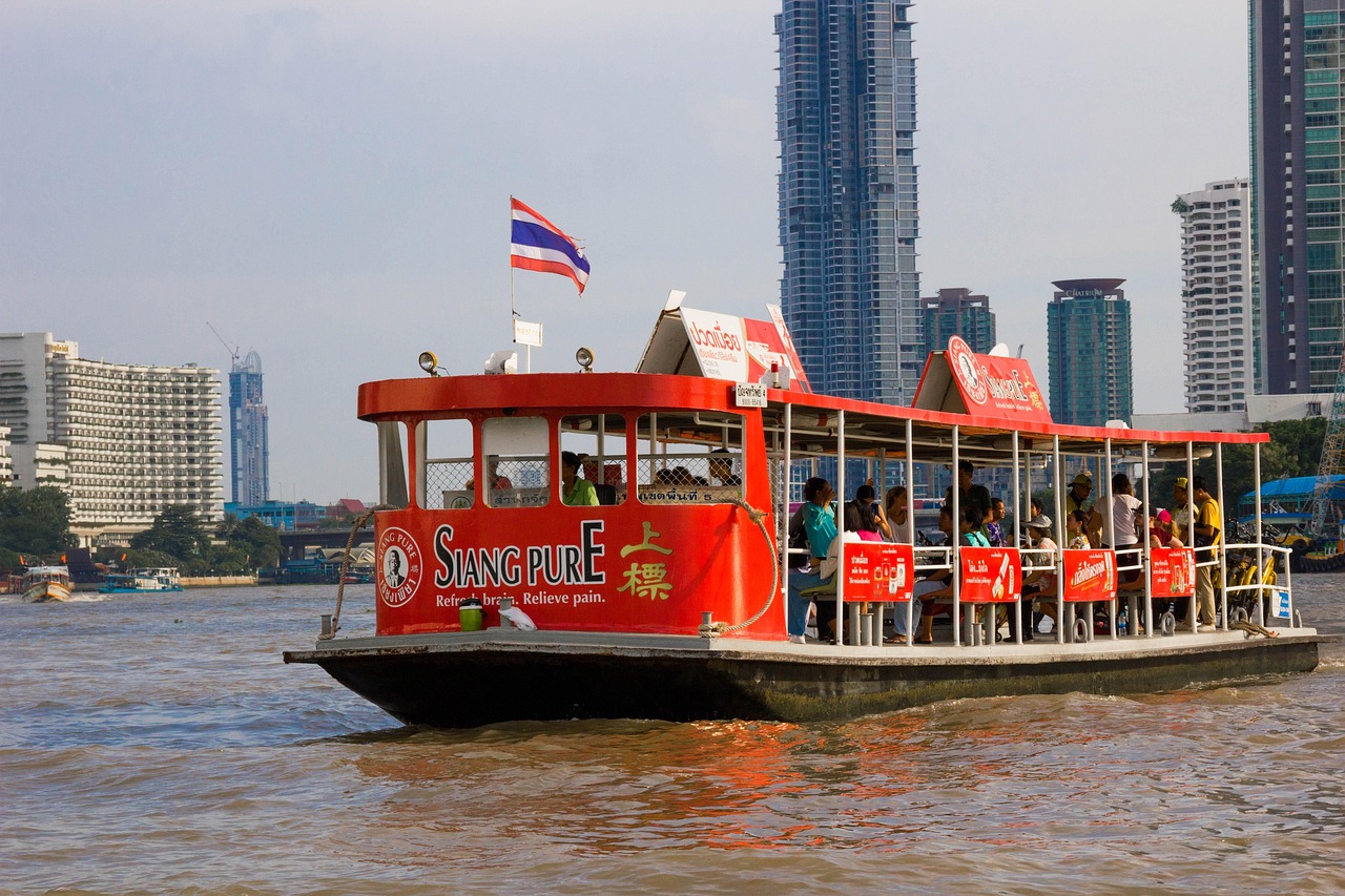A family glides past historic temples on a scenic Chao Phraya River cruise.