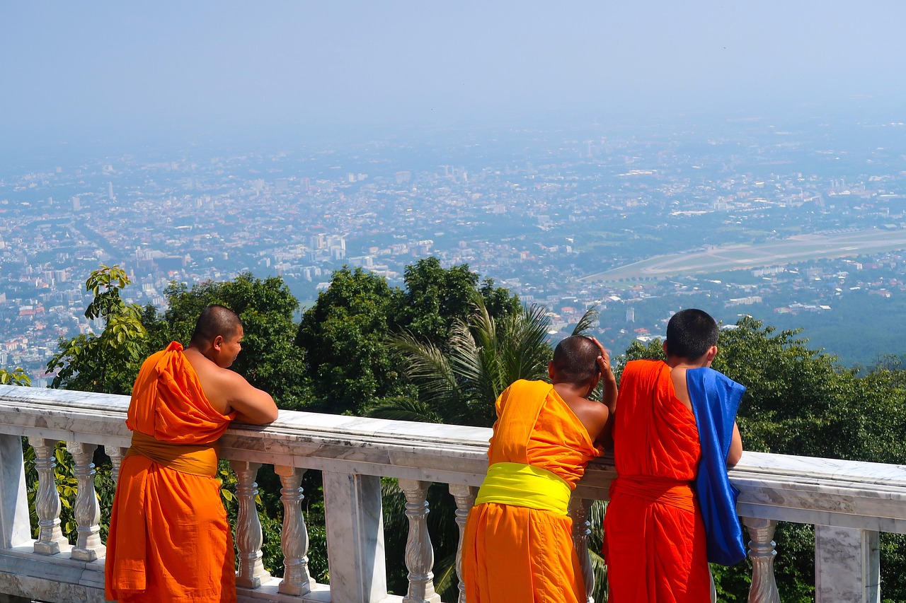 Sacred moments at Doi Suthep Temple: Monks begin their day amidst a golden sunrise.
