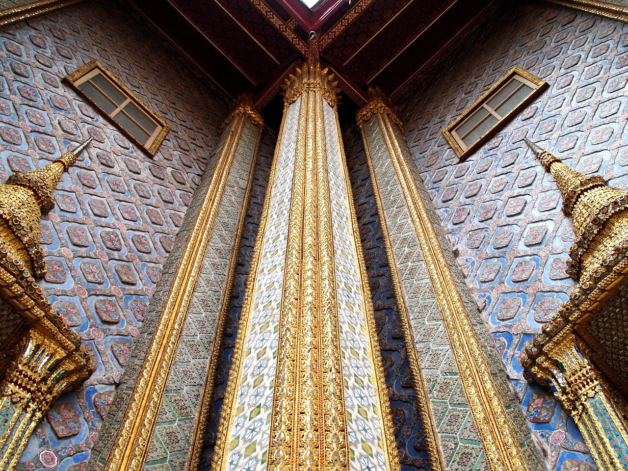 The revered Emerald Buddha sits amidst intricate golden decorations.