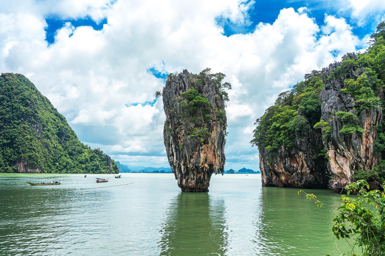 Impressive limestone cliffs rise above the turquoise waters of Kopipi Island, Thailand.
