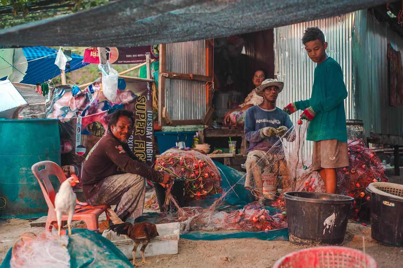 Traditional fishing boats line the shore, reflecting Ko Pang’s enduring maritime heritage.