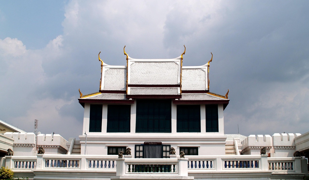 Royal priests changing the Emerald Buddha’s robes—a ceremonial gesture honoring season and tradition.