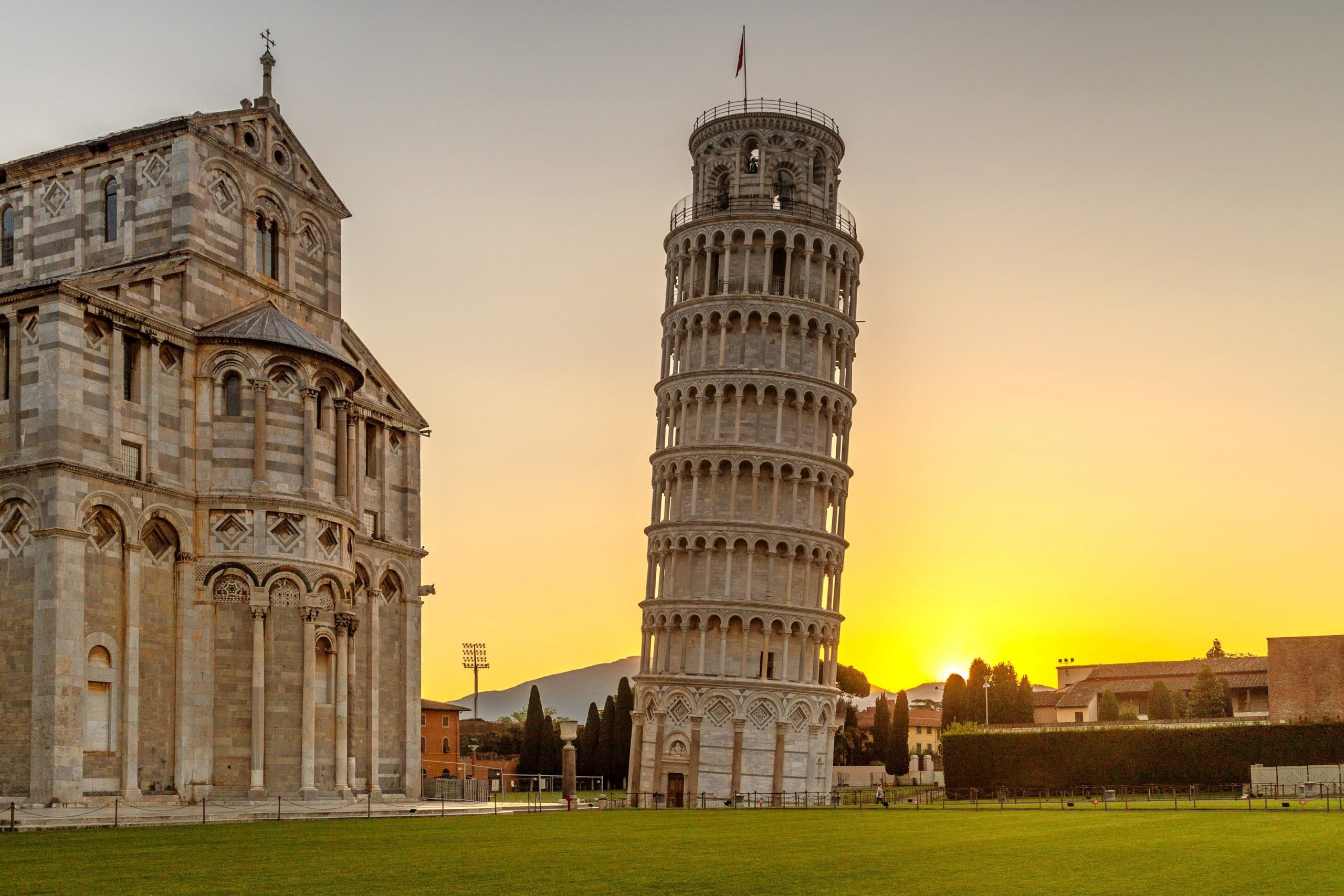 The tower is the campanile, or freestanding bell tower, for the adjacent Pisa Cathedral.