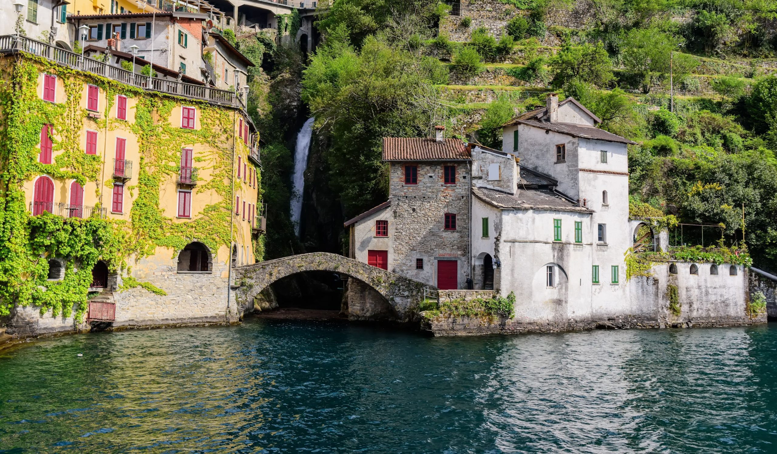 The powerful waterfall at the end of the gorge drops through the village and into the lake.