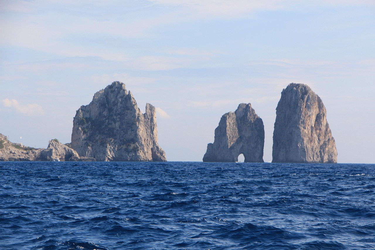 Explore Beyond the Blue Grotto Faraglioni and Wild Water on a boat tour around Capri