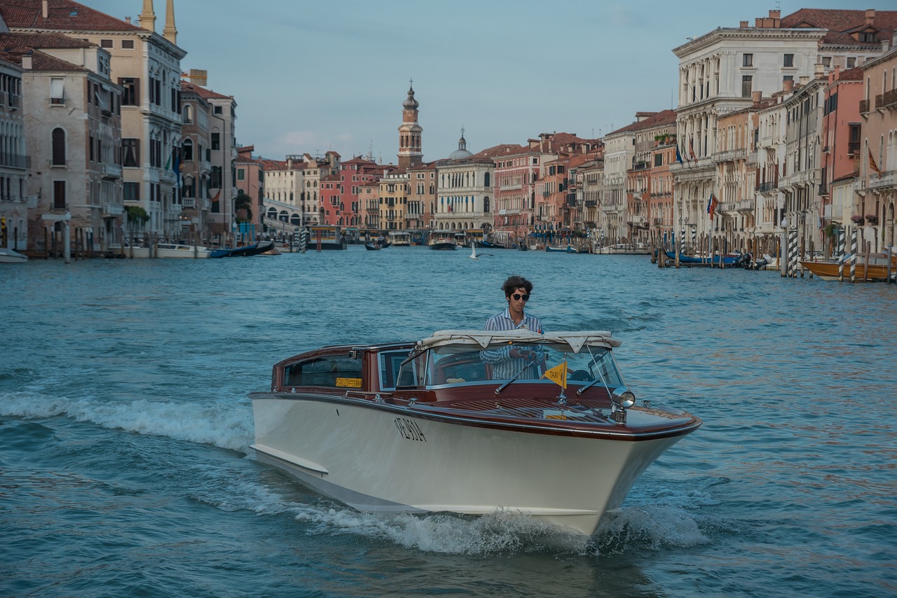 Seamless Venice Logistics Hotels Transport and Tickets with a vaporetto on the canal