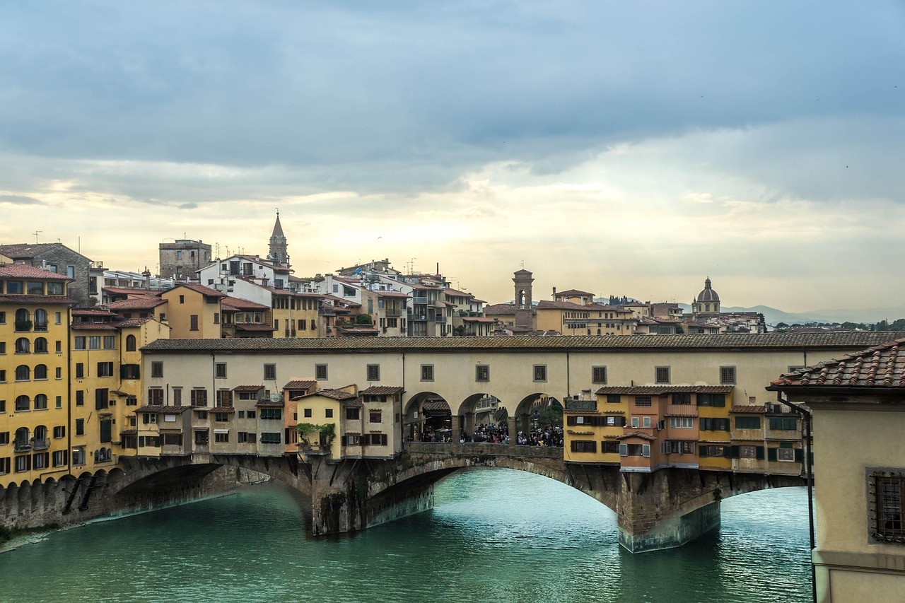 Ponte Vecchio and Piazza della Signoria with local character, jewellery-lit arches over the Arno