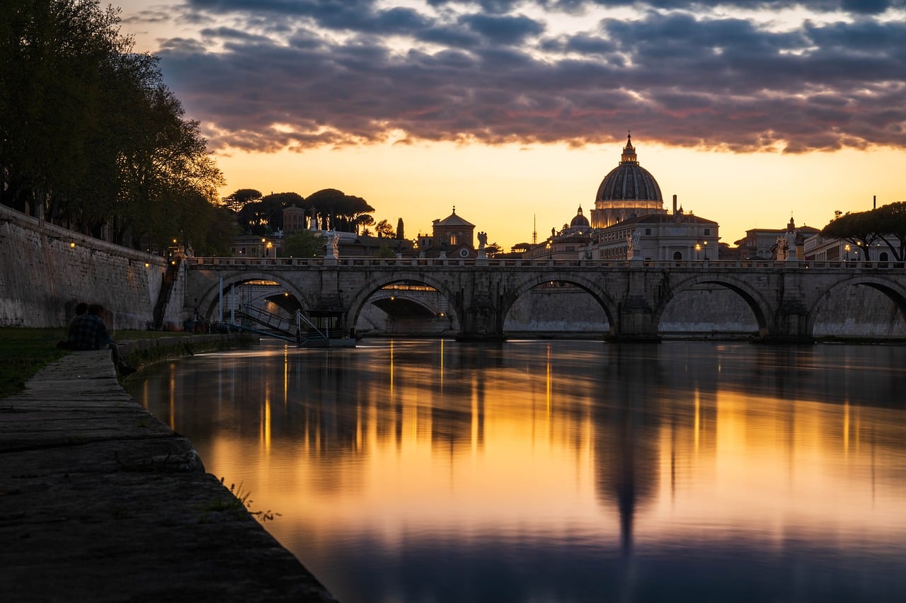 Crafted Roman Dining and a Luxury Tiber Sunset Cruise with glowing monuments along the river