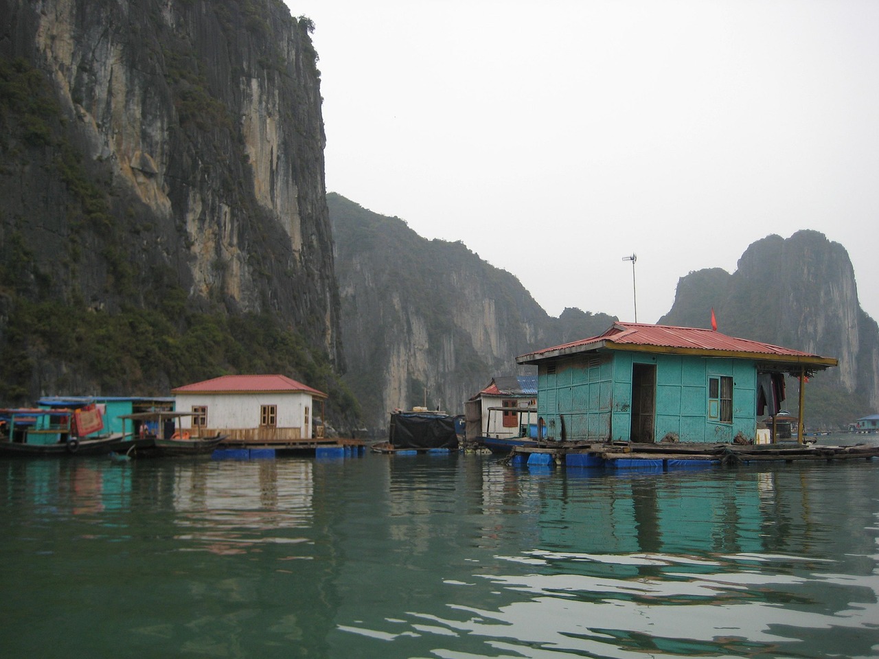 Floating village culture in Cua Van on Ha Long Bay Vietnam with boats at dusk
